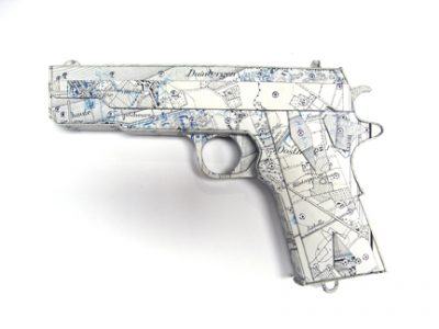 Photo of Ken Kalman's sculpture "Colt 45." Artwork depicts a gun made of maps.