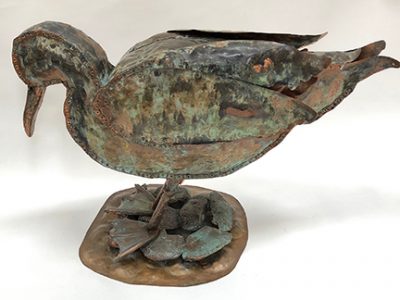 Photo of Ken Kalman's sculpture "Duck." Artwork depicts a copper duck.