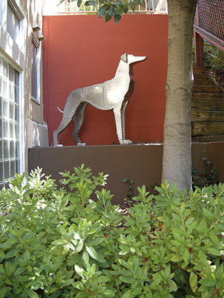 Photo of Ken Kalman's sculpture "Greyhound 2" Artwork depicts an aluminum greyhound dog.