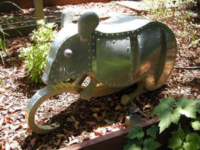 Photo of Ken Kalman's sculpture "Mouse." Artwork depicts an aluminum mouse.