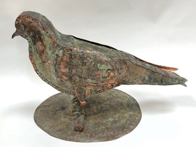 Photo of Ken Kalman's sculpture "Pidgeon." Artwork depicts a copper pidgeon.