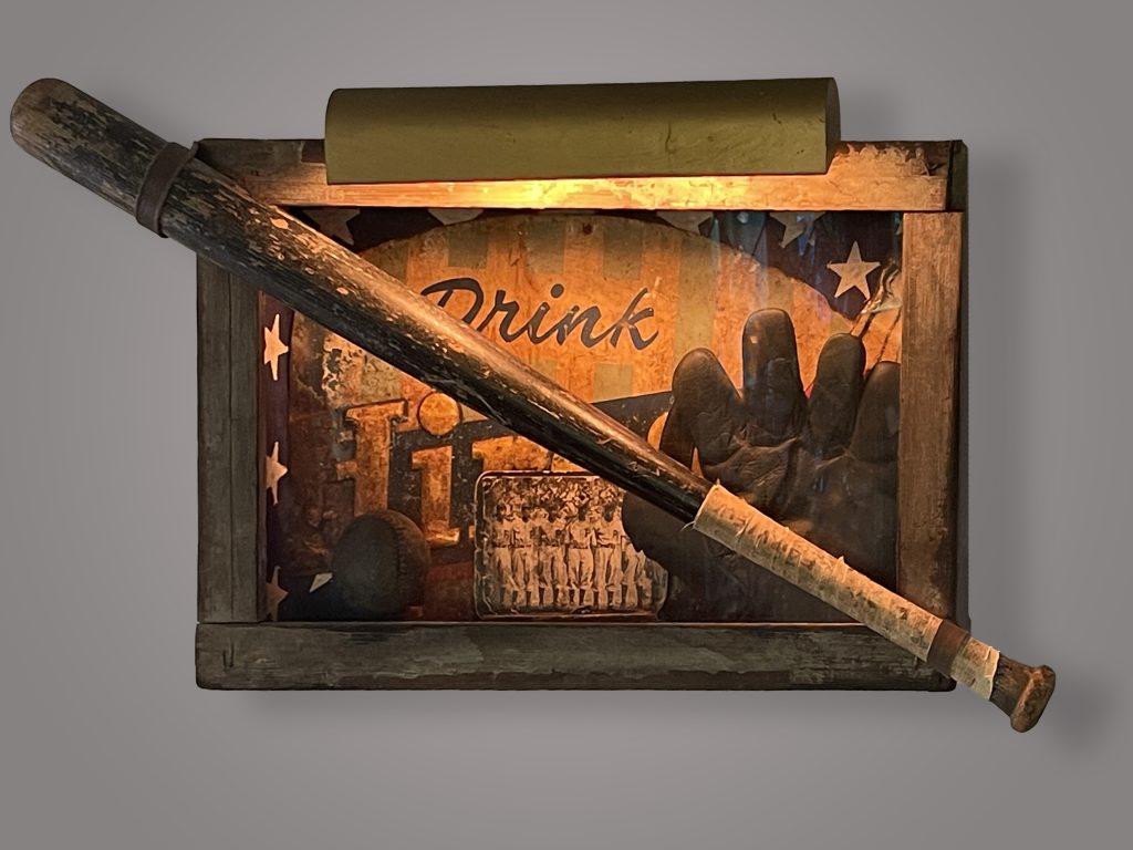 Sculpture of vintage flag & advertising tin, vintage frame & bat, handmade used ball & glove, partial photo of Negro League team found in old bar, old light.