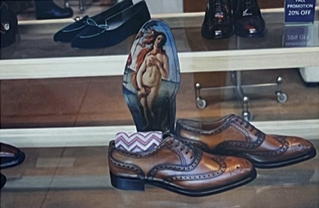 Richard Nagler's color photograph of some men's dress shoes in a store window with an insole depicting Botticelli's Birth of Venus.