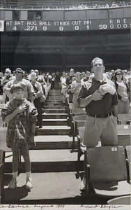 Richard Nagler's black and white photograph of a crowd in the stands at Candlestick Park with hand over heart for the pledge of allegiance.
