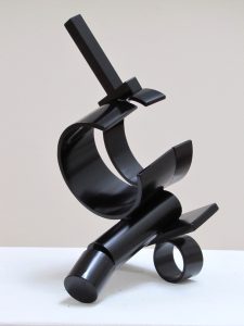 Abstract black metal sculpture of rounded and curved shapes