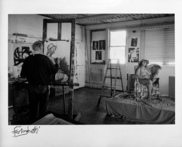 Black and white photograph of Ferlinghetti in his art studio painting a seated nude model.