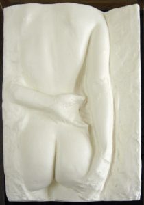 White resin cast of a woman's backside from shoulders to thighs.