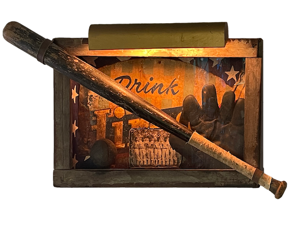 Assembled sculpture of a lighted vintage drink sign, photo of a baseball team, baseball glove and bat.