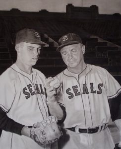Photo of David Lyle's painting "Changing of the Tides." Artwork depicts a baseball player with glove and manager with a ball in Seals uniforms. In the style of a black and white photo.