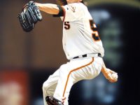 Photo of Arthur K. Miller's painting "Lincecum Windup." Artwork depicts photorealistic Giant's player Tim Lincecum with foot up, arm back about to pitch the ball.