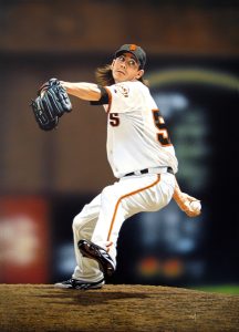 Photo of Arthur K. Miller's painting "Lincecum Windup." Artwork depicts photorealistic Giant's player Tim Lincecum with foot up, arm back about to pitch the ball.