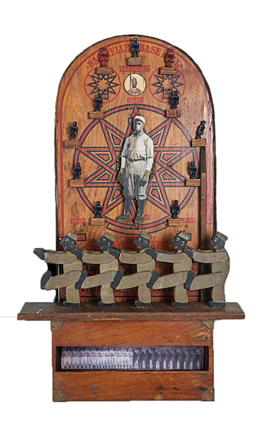 Antique baseball pinball game sculpture with Black player spinner surrounded by metal arcade ballplayers with disc photo of Black soldier on top, recessed photo of Negro League ball team morphing into a segregated military platoon. Handmade wood stereotype Black men in uniforms marching.